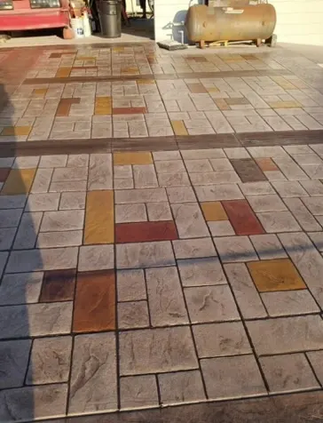 colored stamped concrete in a tile pattern with warm red tones in Royal Palm Beach