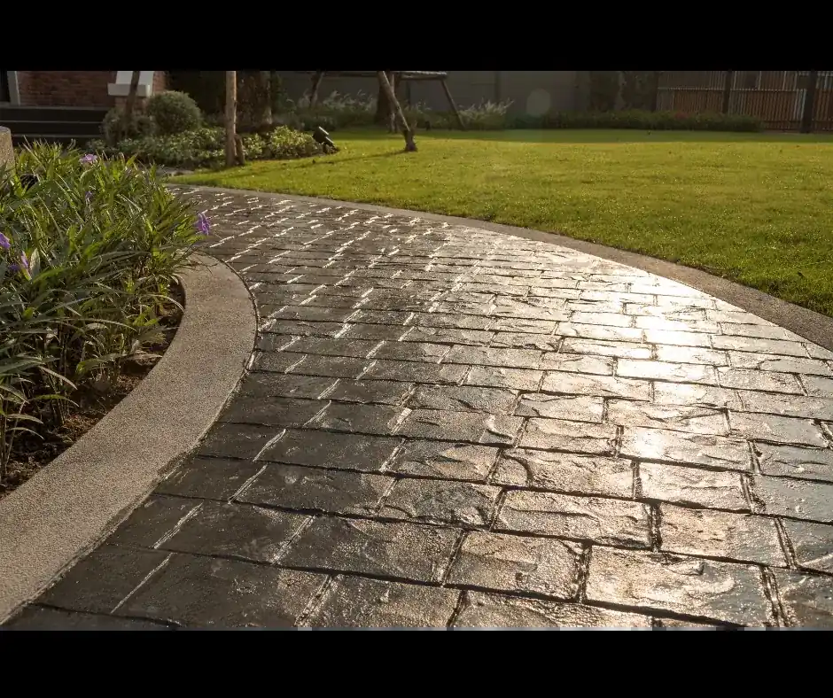 curving stamped concrete walkway in a brick pattern through a yard in Boynton Beach
