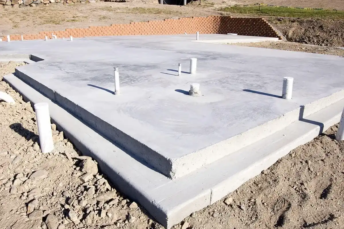 formed concrete slab foundation with stepped edges on bare soil in Royal Palm Beach