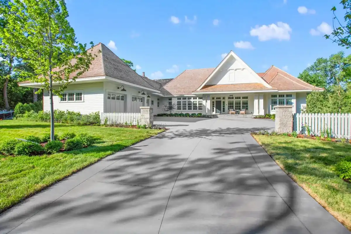 long concrete driveway curving through a shaded lawn to a home in Westlake