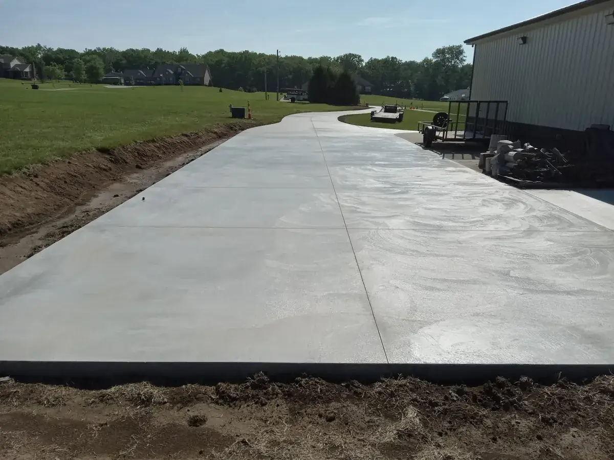 long concrete slab and apron beside a metal building on open land in Pine Air