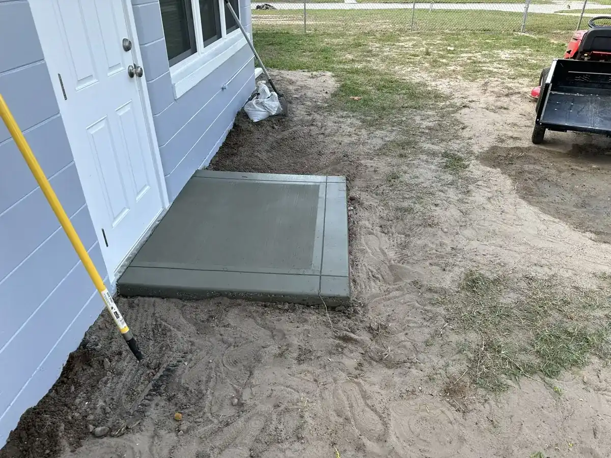 small new concrete pad poured at a side door of a house in West Palm Beach