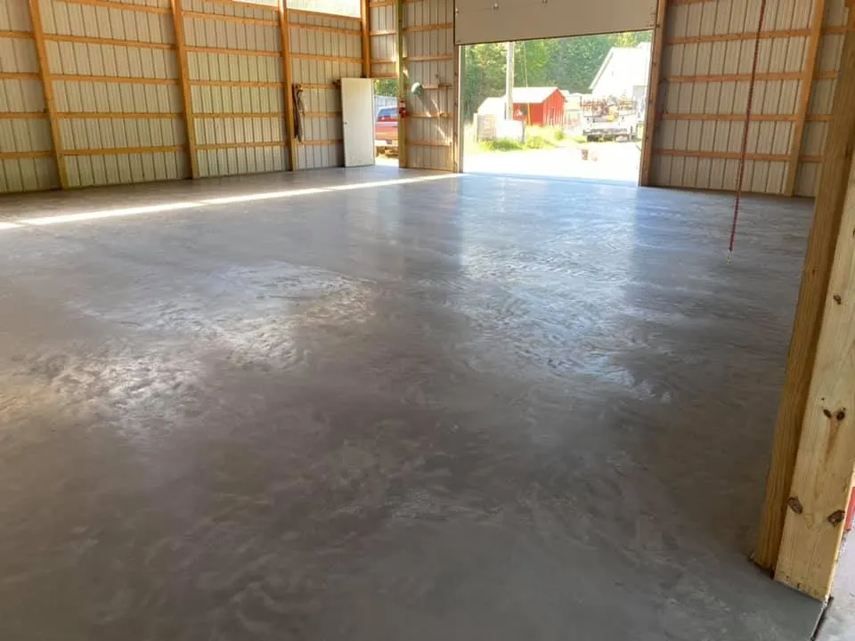 smooth concrete floor slab inside a framed pole barn in Lake Belvedere Estates