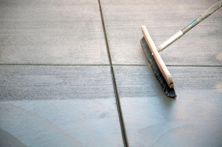 trowel finishing a fresh concrete slab along a control joint in Westlake